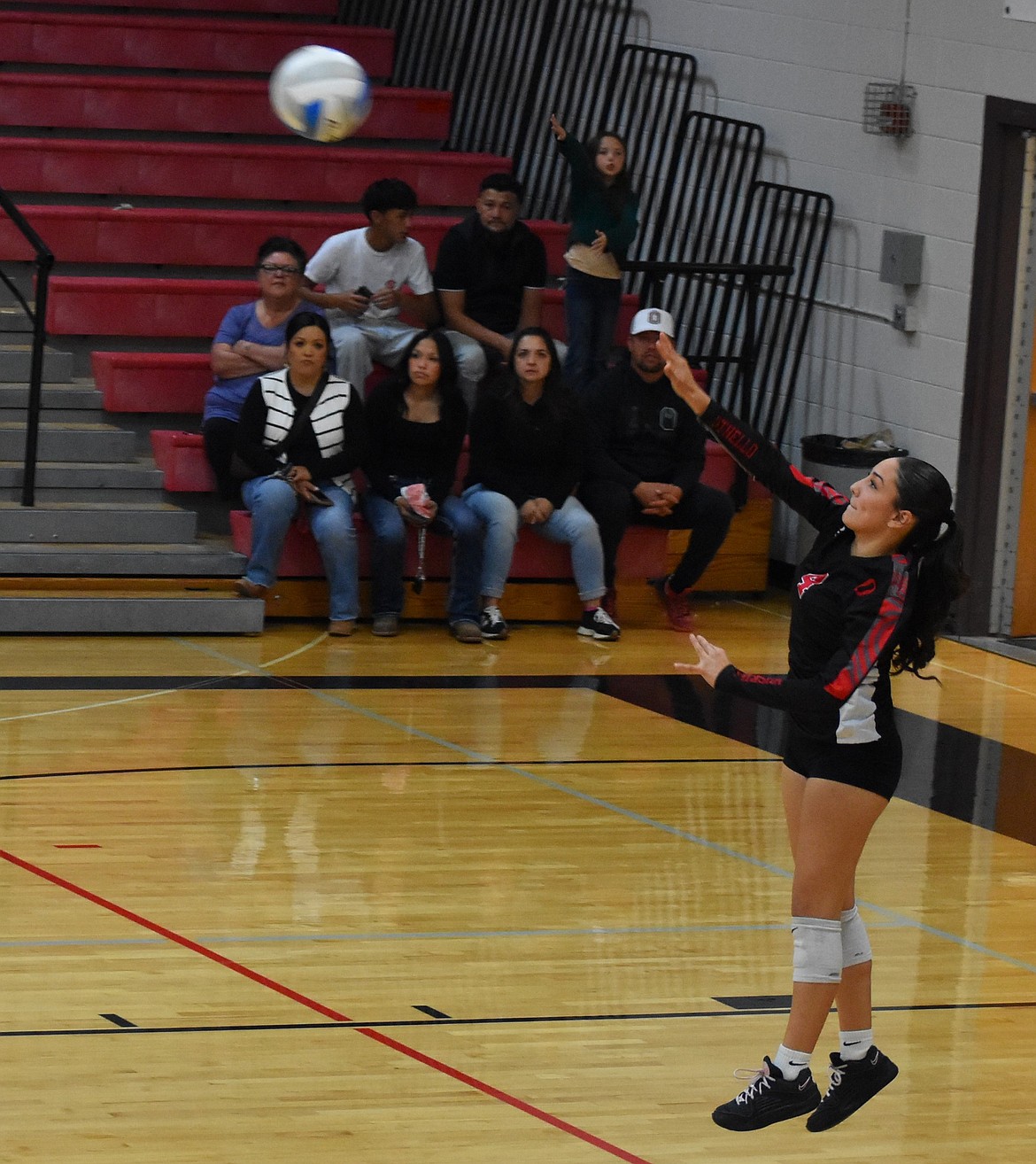 Huskies freshman Jena DeLeon serves the ball during the third set against the Cougars. Huskies head coach Steve Parris said DeLeon had a standout serving performance during Monday’s game.