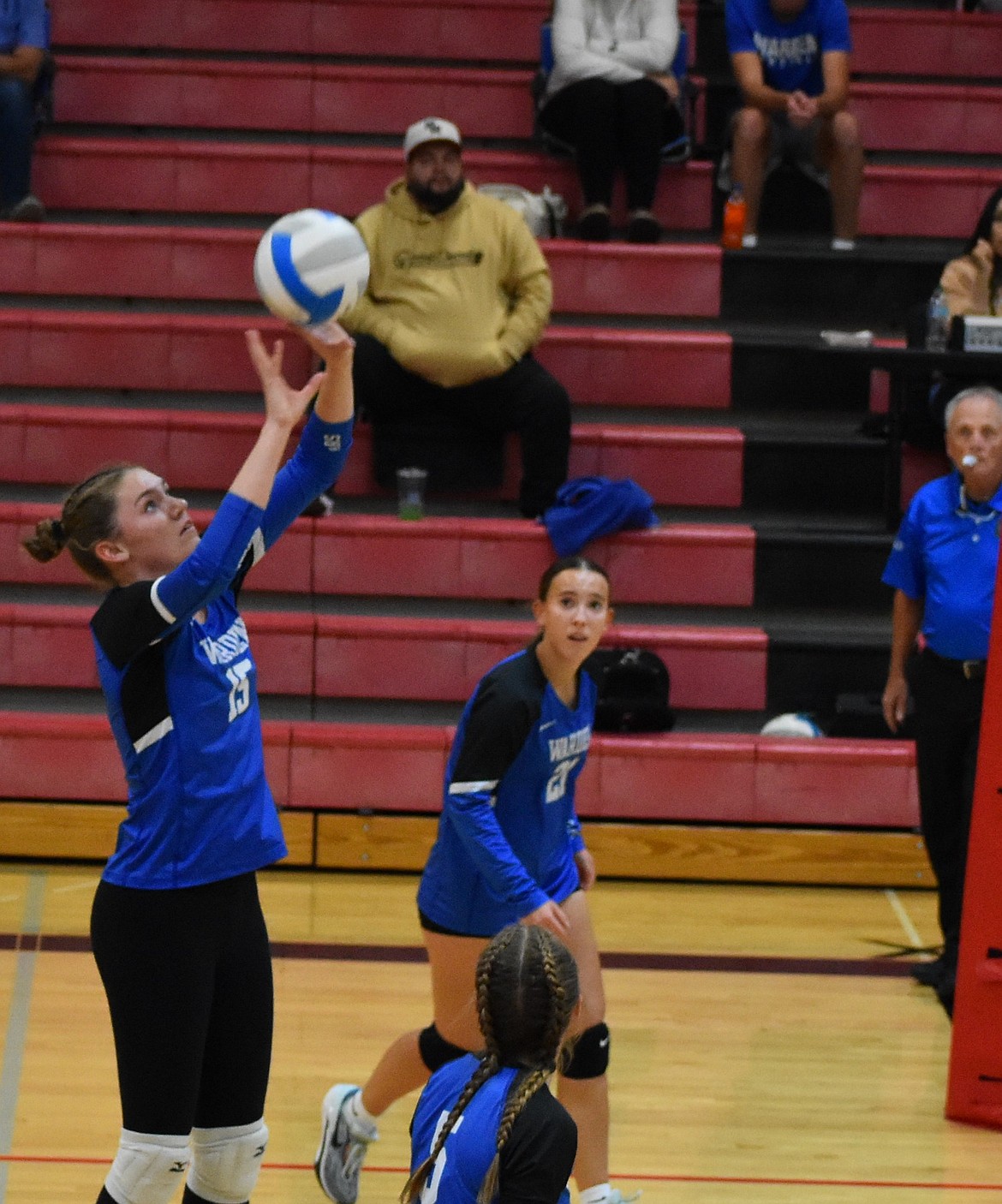 Hannah Roylance from the Cougars sets the ball up for one of her teammates to hit over the net during Monday’s game. Both the Cougars and the Huskies had a busy week with only one day of practice between games.