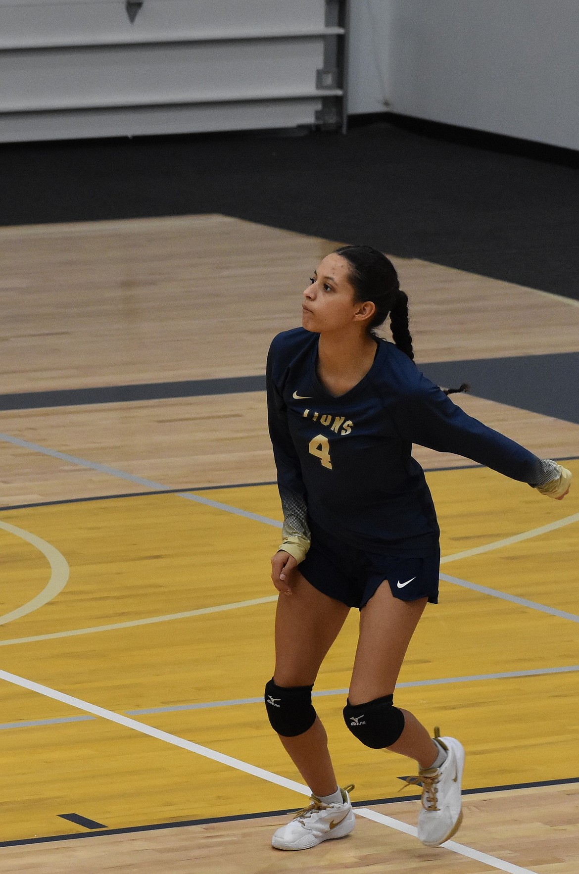 Lions senior SanTahna Ferguson sprints into position following her serve against the Eagles. Ferguson said the Lions showed team unity throughout the game and triumphed over illness.