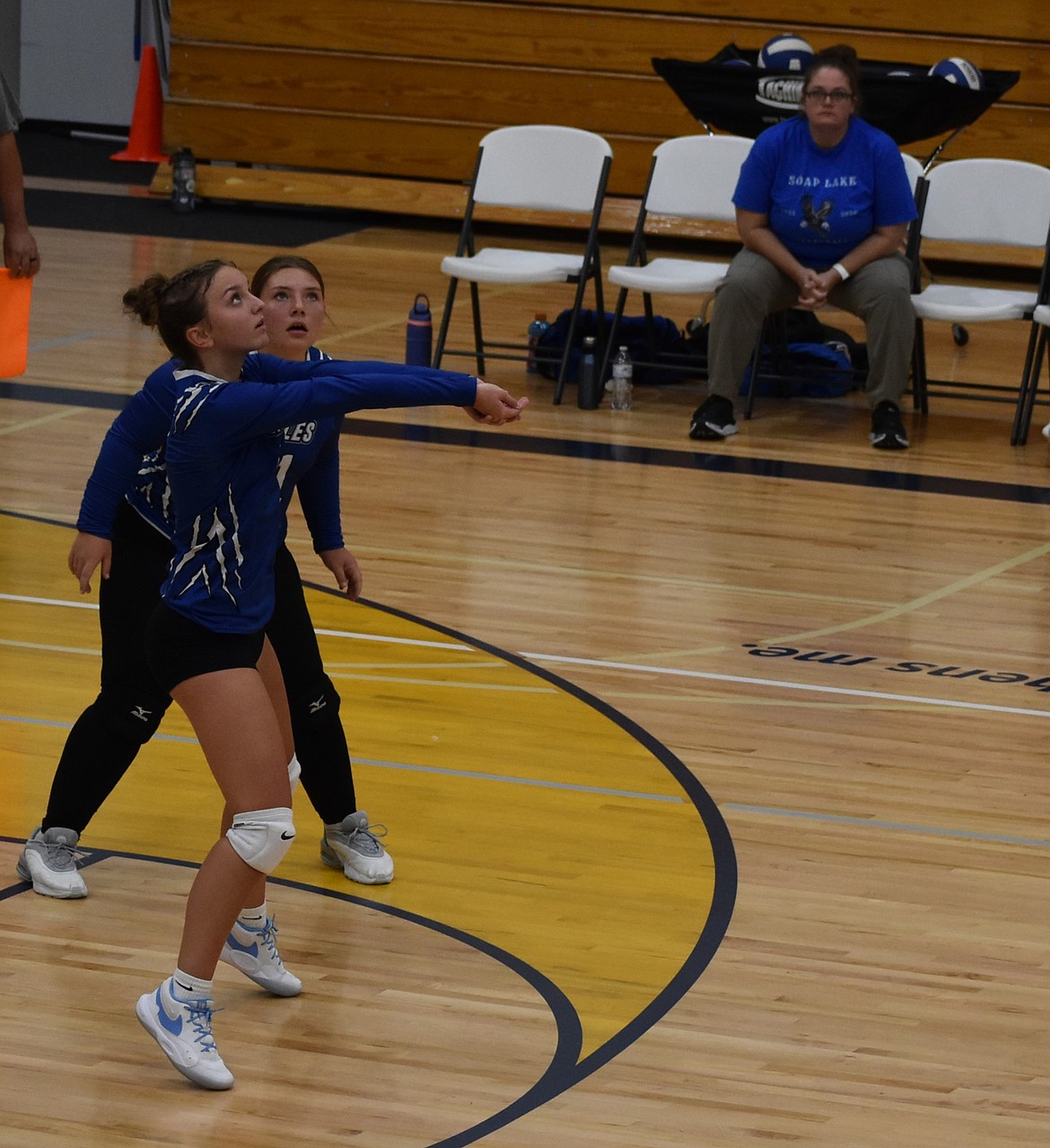 Eagles player Marina Zubritskiy (7) bumps the ball up into the air following a serve to the middle from the Lions while her teammate, Alyson Zufall (11), keeps an eye on the ball from behind.