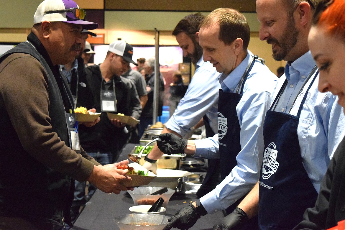 Washington and Oregon Potato Commission members serve attendees at the baked potato bar at the 2025 Washington-Oregon Potato Conference.
