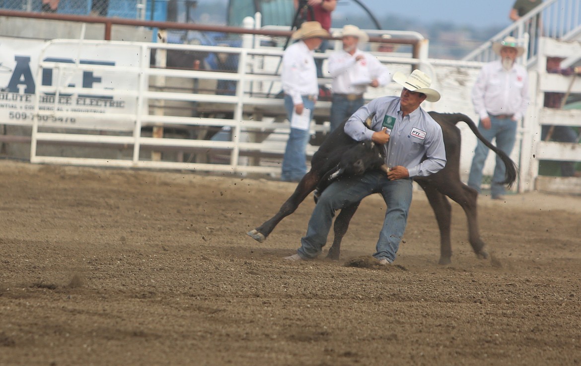 A steer wrestler takes on a four-legged opponent in the Moses Lake Roundup Rodeo. The PRCA recently named Billy and Pam Minick of Texas as the recipients of the 2025 Legend of ProRodeo award.