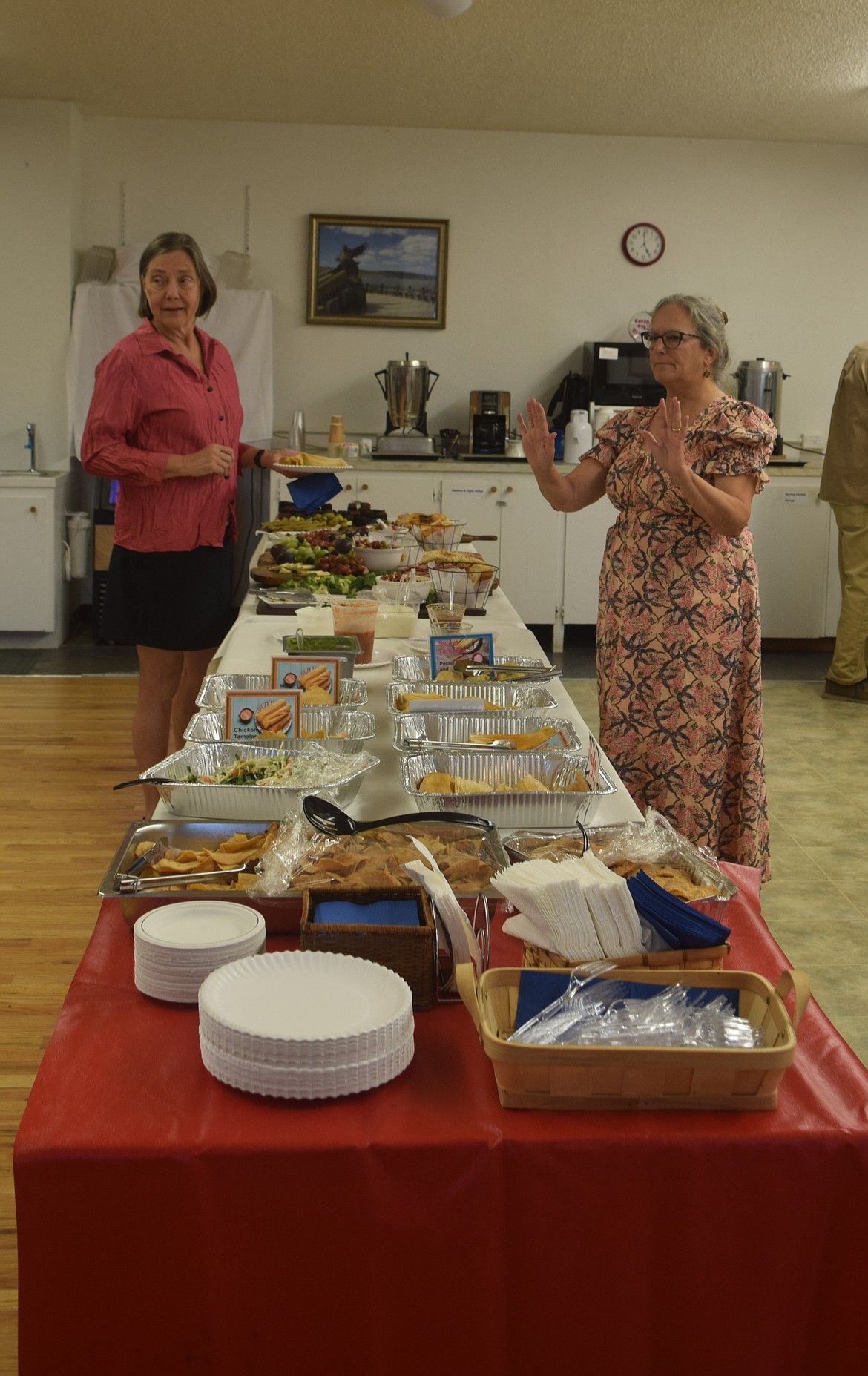 Creative District organizer Ruthann Tobiason, right, greets former council member Leslie Taylor at the Soap Lake Creative District Celebration. The event was catered by multiple local restaurants.