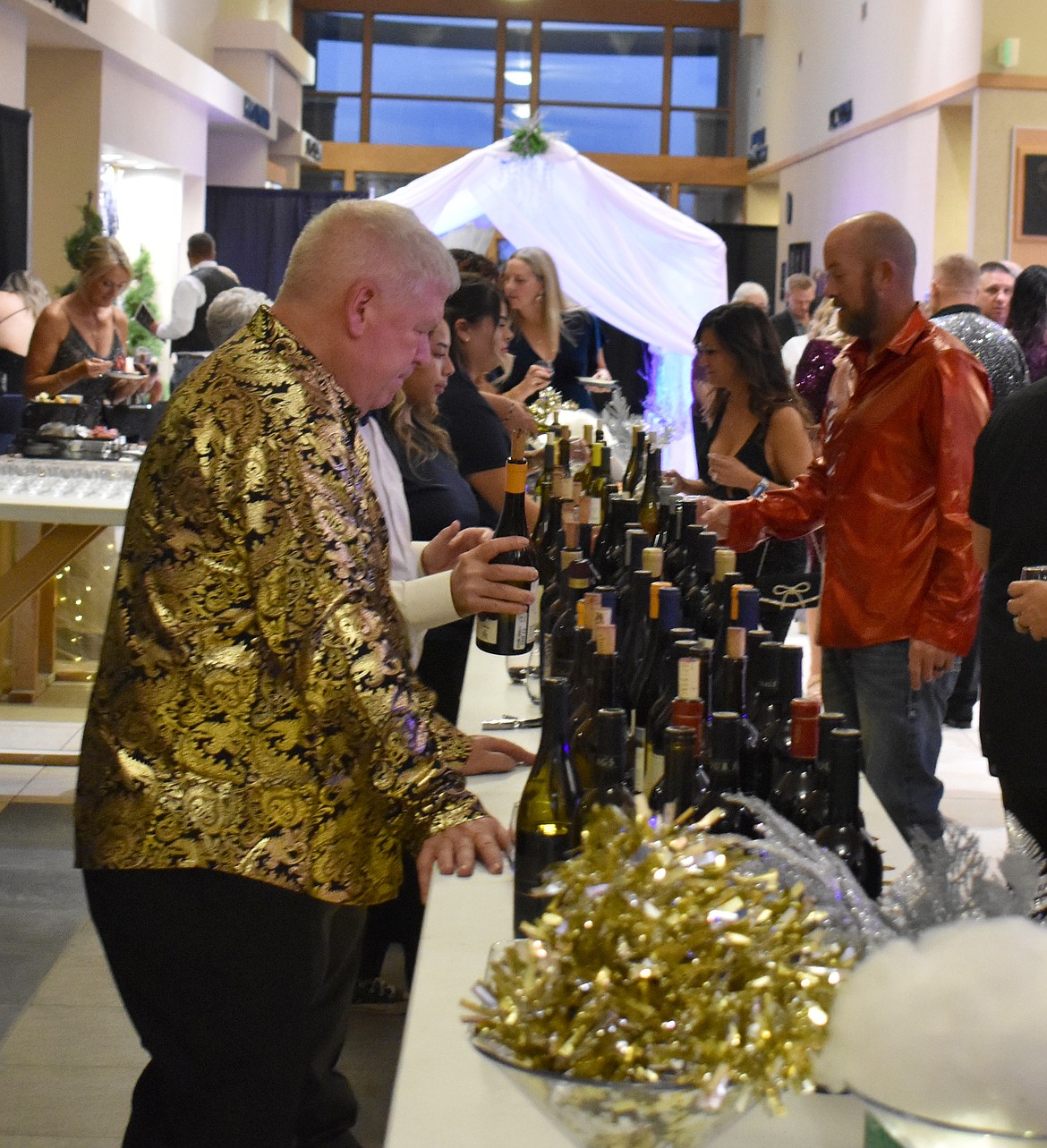Group14 Plant Manager Don Kersey of Moses Lake presides over the wine table at the Boys & Girls club auction Saturday.