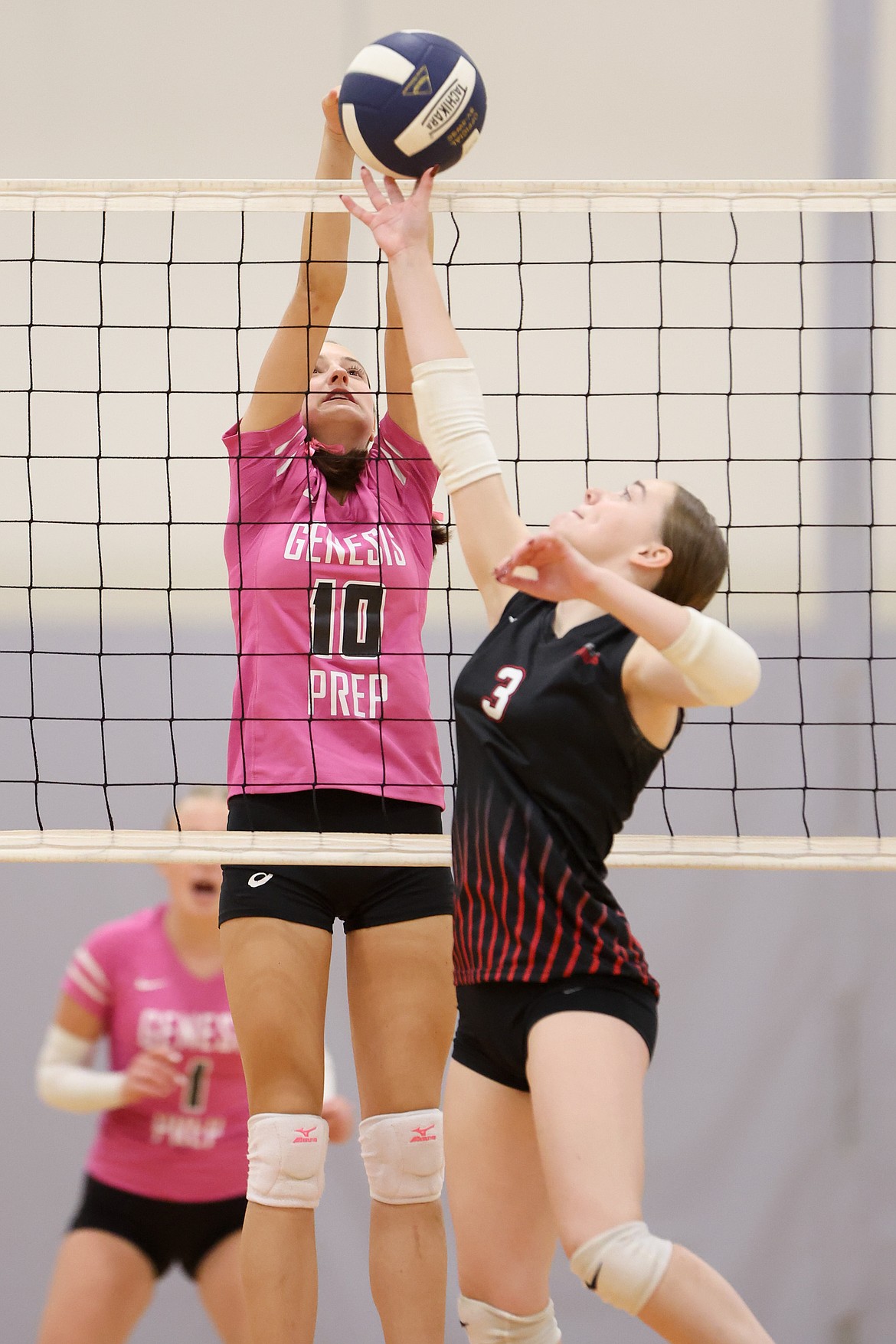 JASON DUCHOW PHOTOGRAPHY
Genesis Prep senior Mabel Long (10) goes up for the block as Aubrey Birdsell (3) of Wallace reaches for the ball Thursday night at The Courts at Real Life in Post Falls.