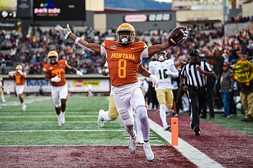 Grizzlies cornerback Kenzel Lawler (8) returns an interception 21 yards for a touchdown in the third quarter against Cal Poly at Washington-Grizzly Stadium on Saturday, Oct. 11. (Casey Kreider/Daily Inter Lake)