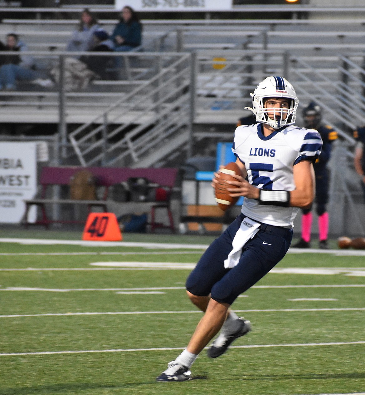 The Lions quarterback Johnny Ferguson looks downfield to an open receiver during Friday’s game. Head coach Josh Kast said the team has made great progress on offense and will continue to diversify their plays for the rest of the season.