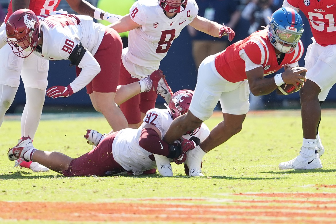 Mississippi quarterback Trinidad Chambliss (6) is tackled by Washington State defensive lineman Darrion Dalton (92) during the second half of an NCAA college football game, Saturday, Oct. 11, 2025, in Oxford, Miss.