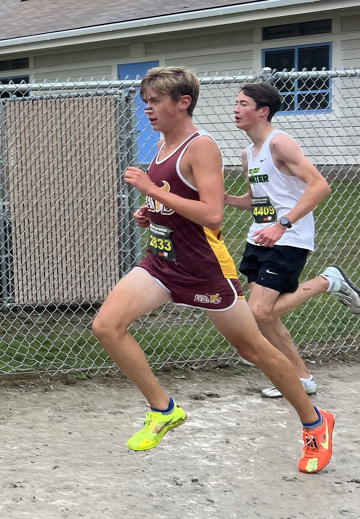 Lane Christensen from the Mavs rushes past a runner from a competing school at the Nike Hole in the Wall Invitational. Christensen finished the race with a time of 16:38.3.