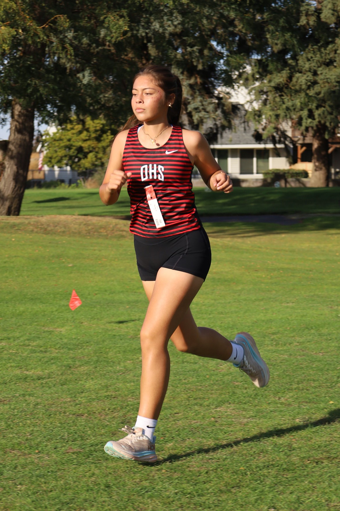 Iris Gomez from the Huskies runs along the path during the Max Jensen Invitational on Saturday.