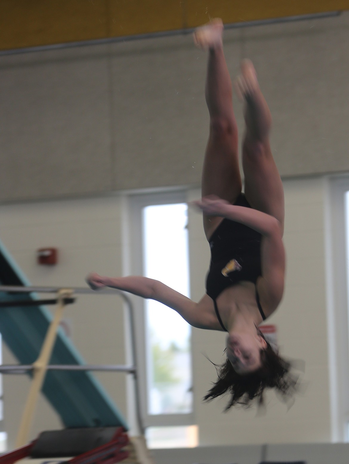Chloe Saxton does a flip during the 1-meter dive on Thursday. Saxton placed first for the Mavericks and improved her score in the same competition from the previous meet.
