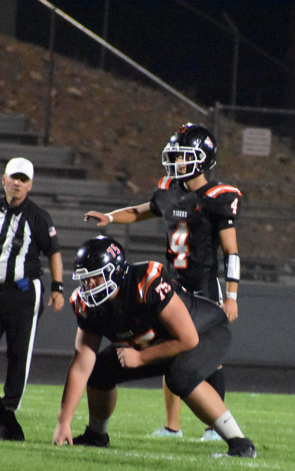 Tigers kicker Caleb Moberg, filling in for quarterback, stands behind center Gabriel Mack during the final quarter of a previous game this season. Head coach Patrick Mitchell said the Tigers had been preparing diligently in these last few weeks for the games ahead.
