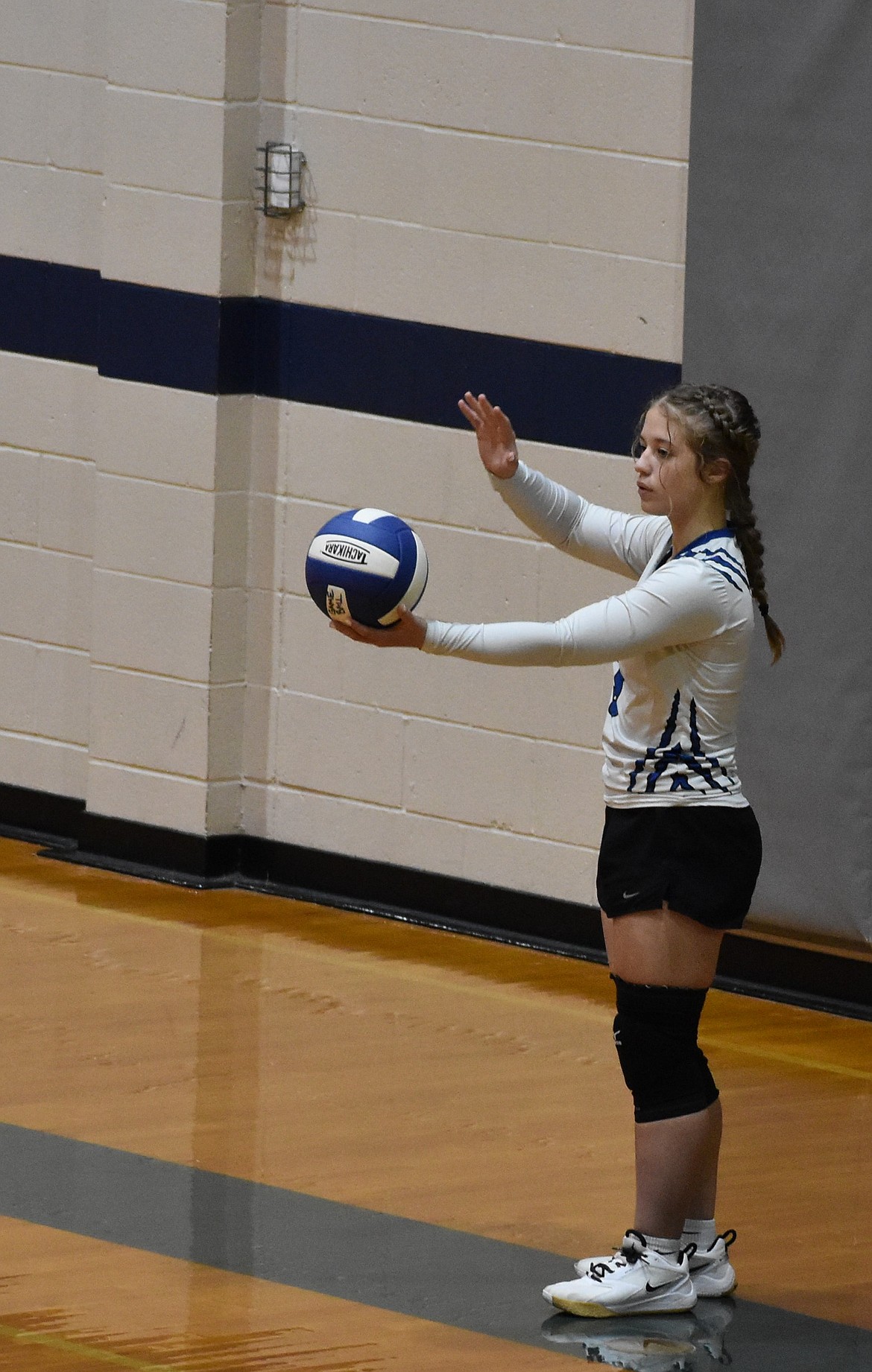 Ellie Schopf, a senior for the Eagles, gets ready to serve the ball during Tuesday’s matchup. Eagles head coach Niki Noble said the team came out strong from the very beginning which was necessary to win the game.