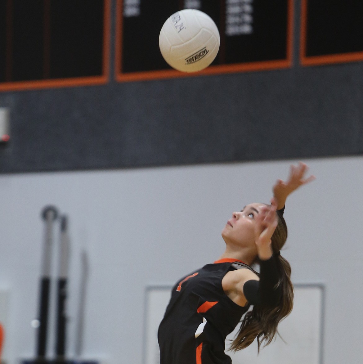Tigers player Faith Rodriguez (1) leaps into the air as she serves the ball to Mavericks on Thursday.