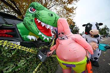Costumed trunk-or-treaters collect candy and goodies at the trunk-or-treat event held by the Evergreen Chamber of Commerce at Evergreen Junior High on Saturday, Oct. 25. (Casey Kreider/Daily Inter Lake)