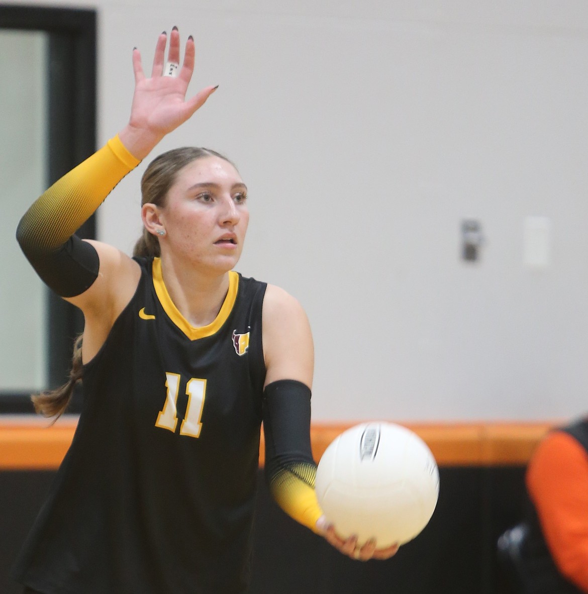 Kardyn Martinez (11) looks across the court as she steps into her serve. Martinez had 15 kills and 10 blocks against Prosser in their win on Saturday.