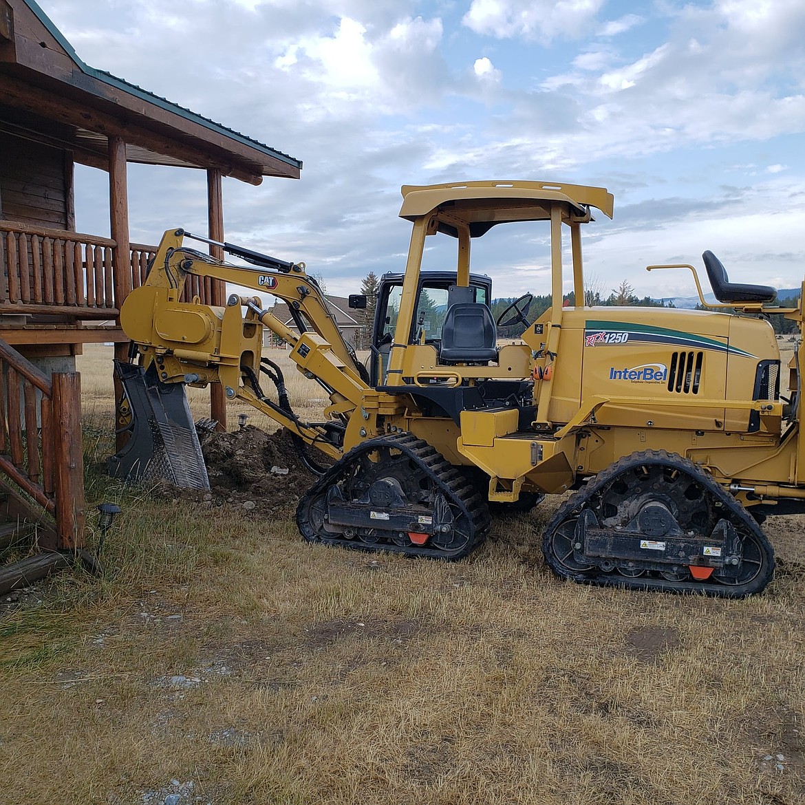 Construction crews with Interbel install fiber near a residence. (photo courtesy of BroadbandMT)