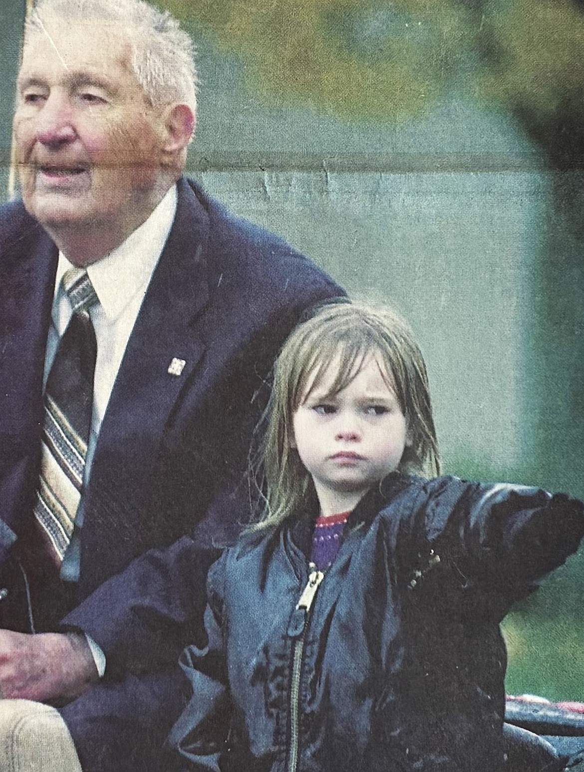 A little girl gives a Nazi salute while riding with Aryan Nations leader Richard Butler in a Sherman Avenue parade in 2000.