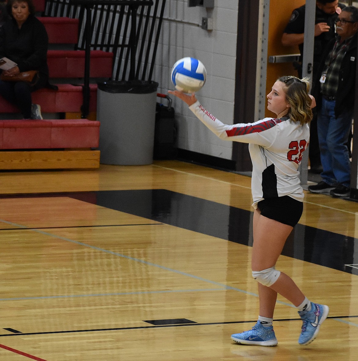 Addie Roylance, a junior for the Huskies, gets ready to serve the ball.