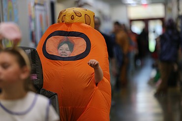 Second grader Zachery Wright as Mr. Cheese from the video game "Among Us" gleefully walks Friday morning through the halls of Winton Elementary School during Winton's annual Halloween parade.