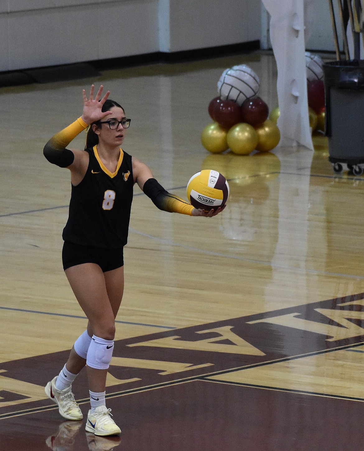 Caitlyn Decubber, a senior for the Mavs prepares to serve the ball during Thursday’s matchup. Decubber earned 14 kills during the game and had great success on serves in the first set.