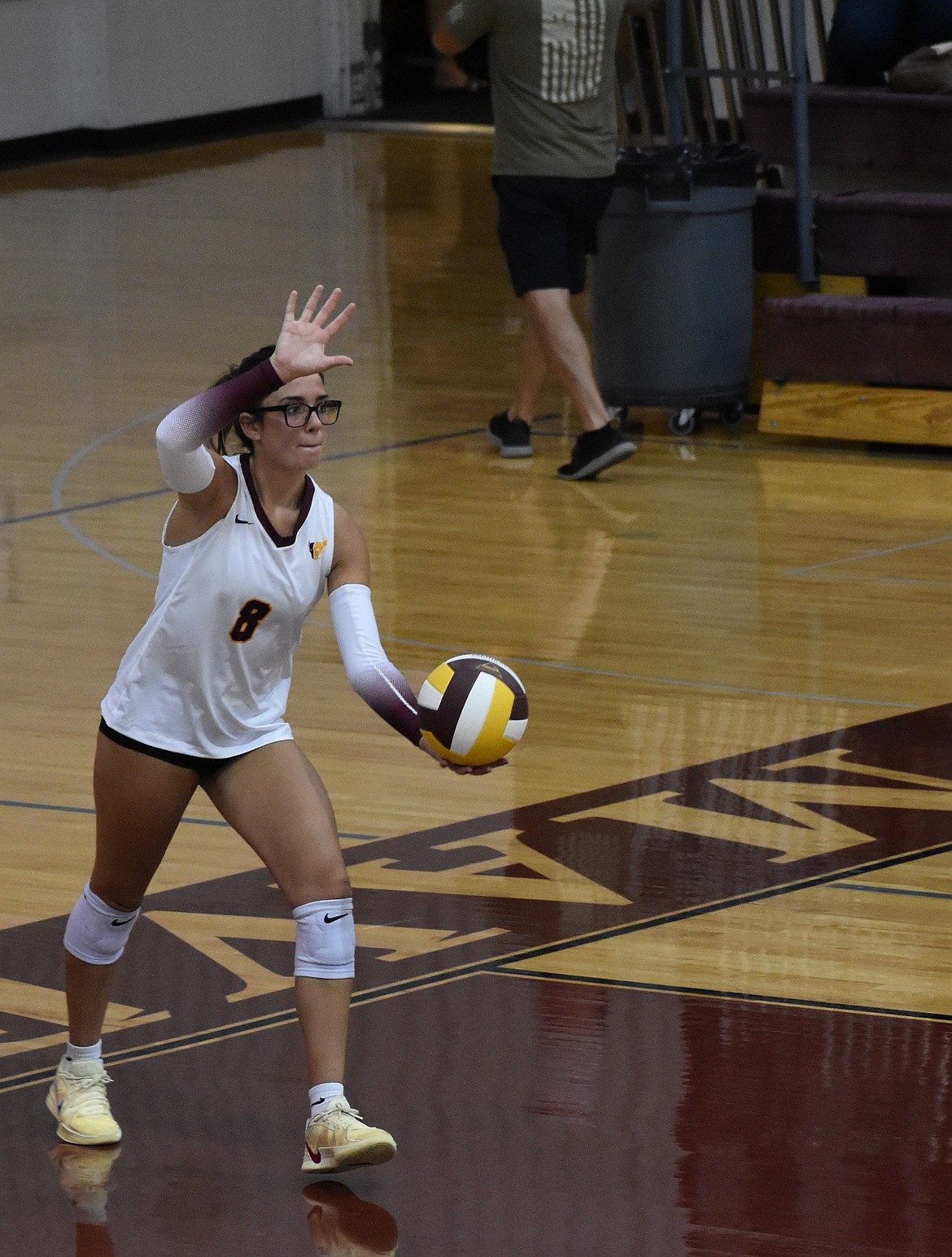 Caitlin Decubber, a senior from the Mavs, gets ready to serve the ball during a prior home game. Decubber earned honors for first team this season.