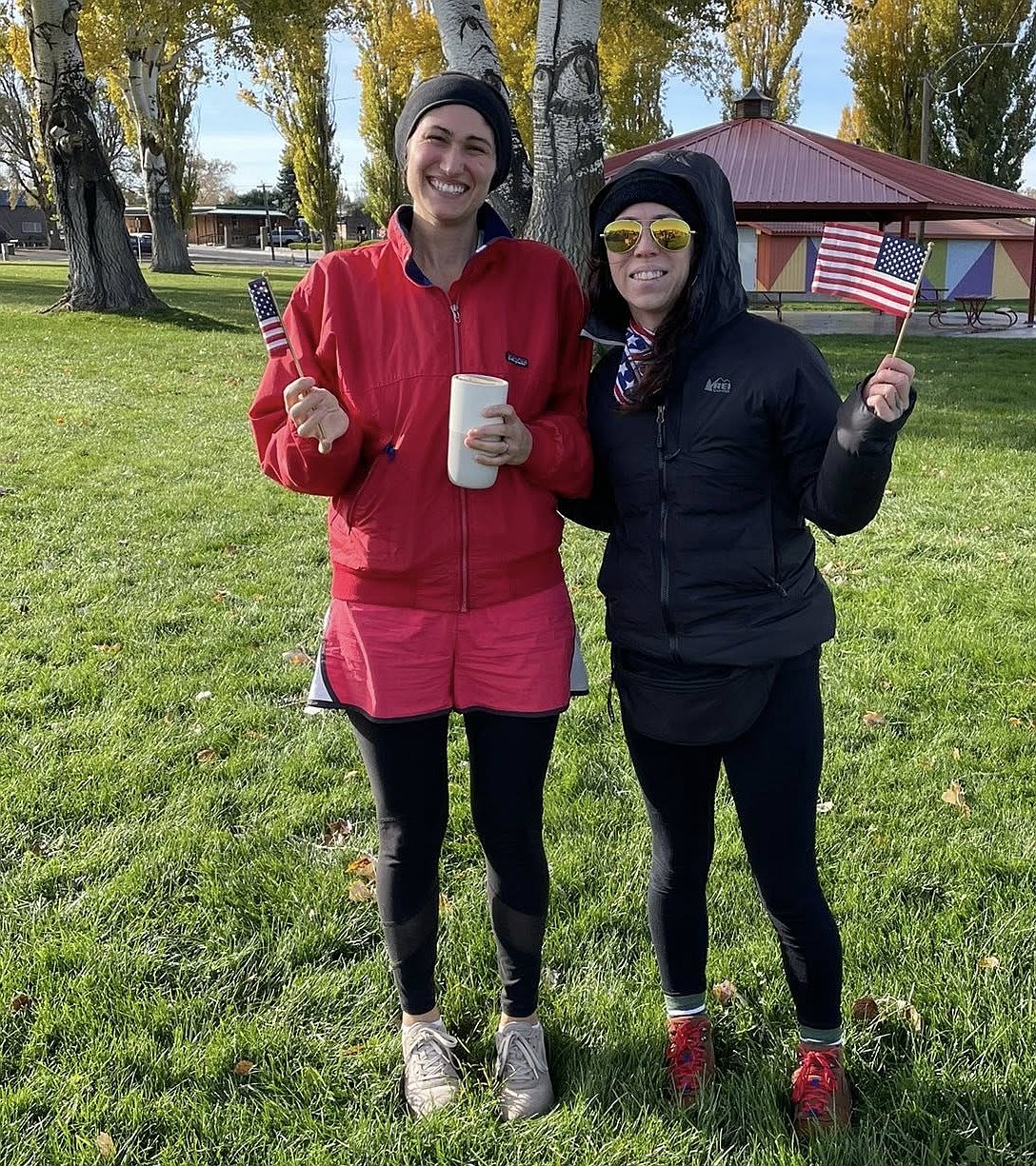 Two runners hold up their American flags at the Soap Lake Salutes Fun Run. Event organizer Britton Baker said 10 runners attended the event on Saturday.