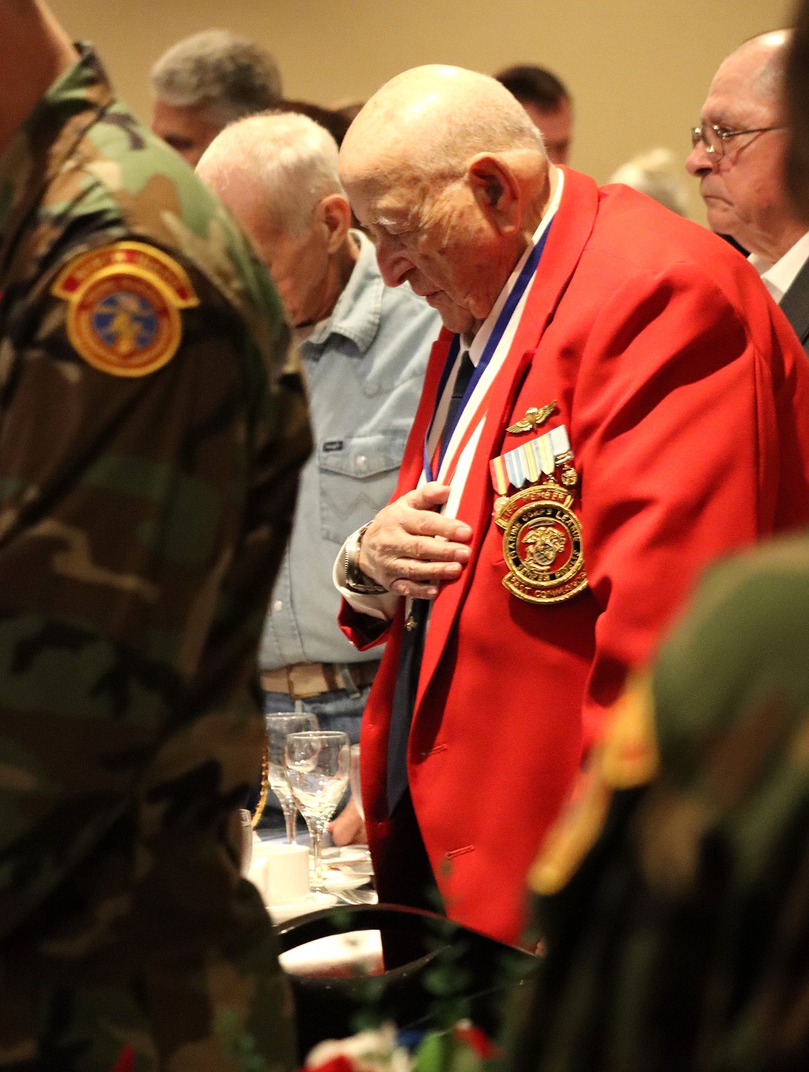 A veteran bows his head in prayer at the 250th Marine Corps Birthday Ball on Monday.