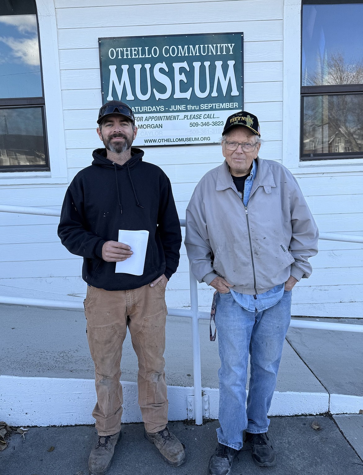 Steve Lichtenegger, left, of Steve’s Refrigeration & Heating, and Othello Community Museum board char Eric Morgan, right, with the contract to upgrade the museum’s heating and cooling systems.