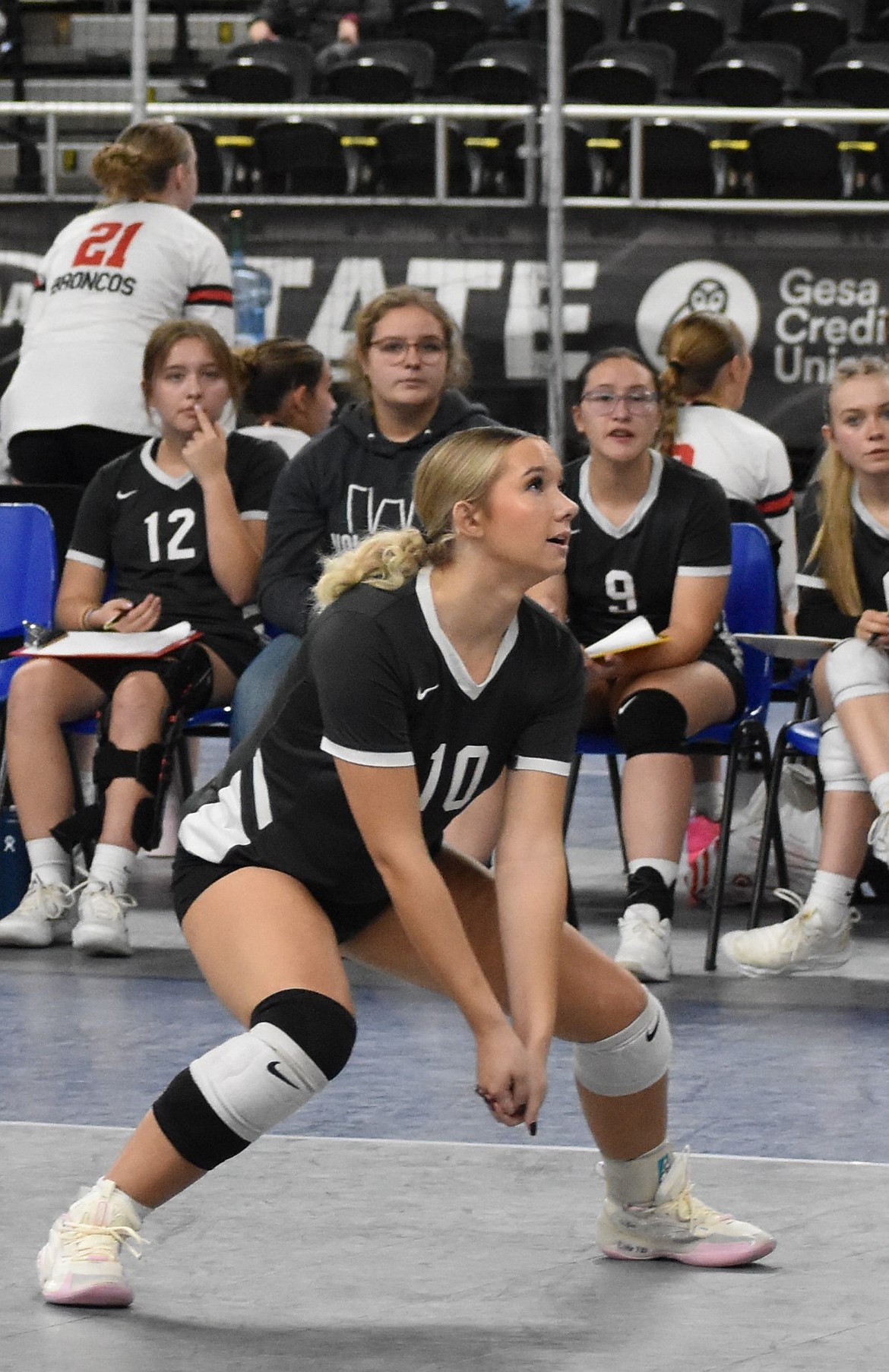 Savannah Monson (10) steps into an incoming ball for a bump pass in the state tournament.