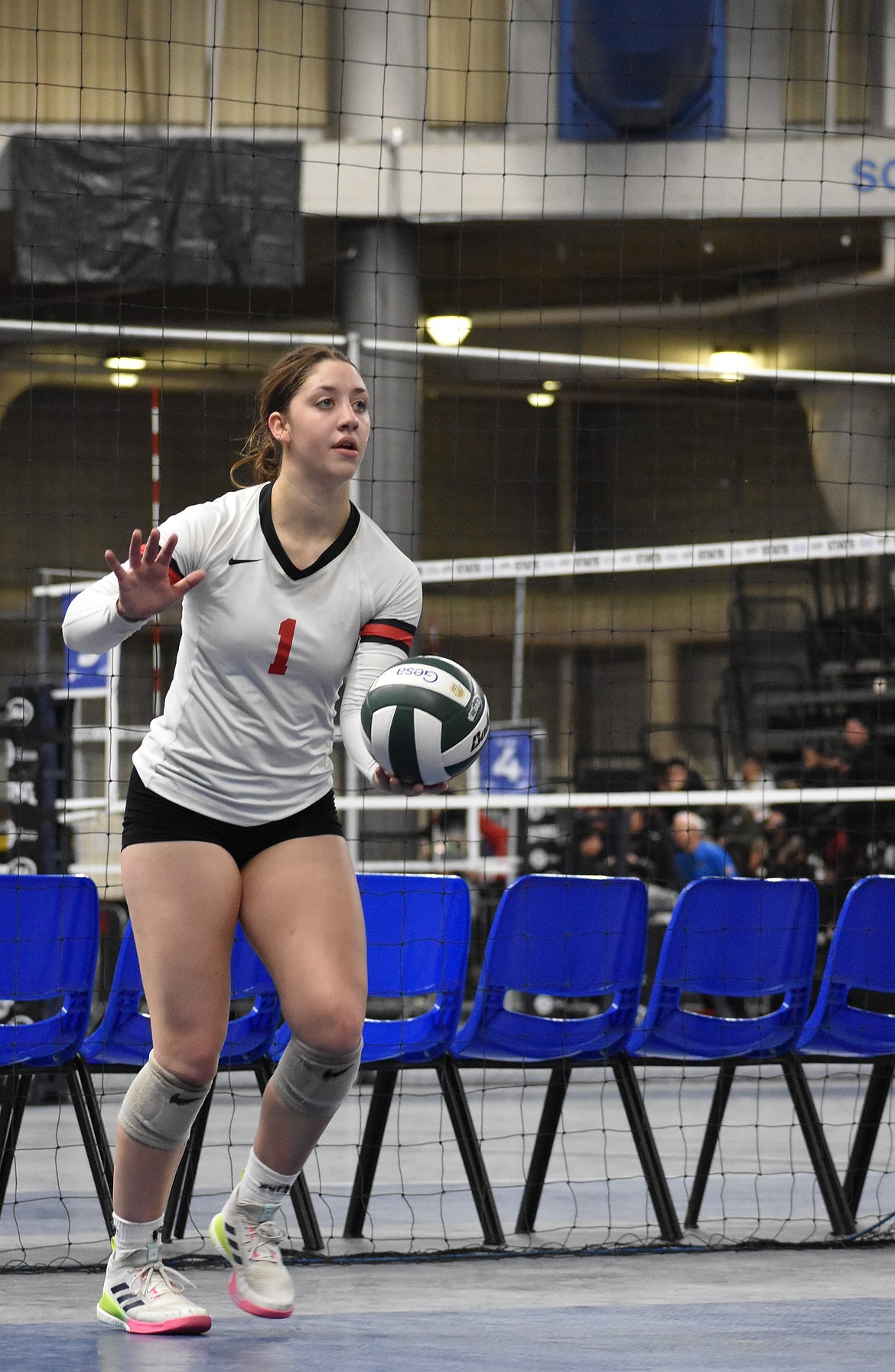 Warriors senior Peyton Roberts hits the ball backwards back over the net during the team’s close matchup against Oakesdale.