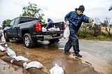 Atmospheric river hits Southern California with risks of flash floods and deaths on stormy seas