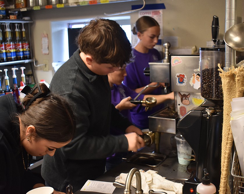 Students from the Othello First Presbyterian Church youth group scramble to keep ahead of the coffee orders at Coffee for a Cause Sunday. The money raised will go to buy new shoes for Othello school children.