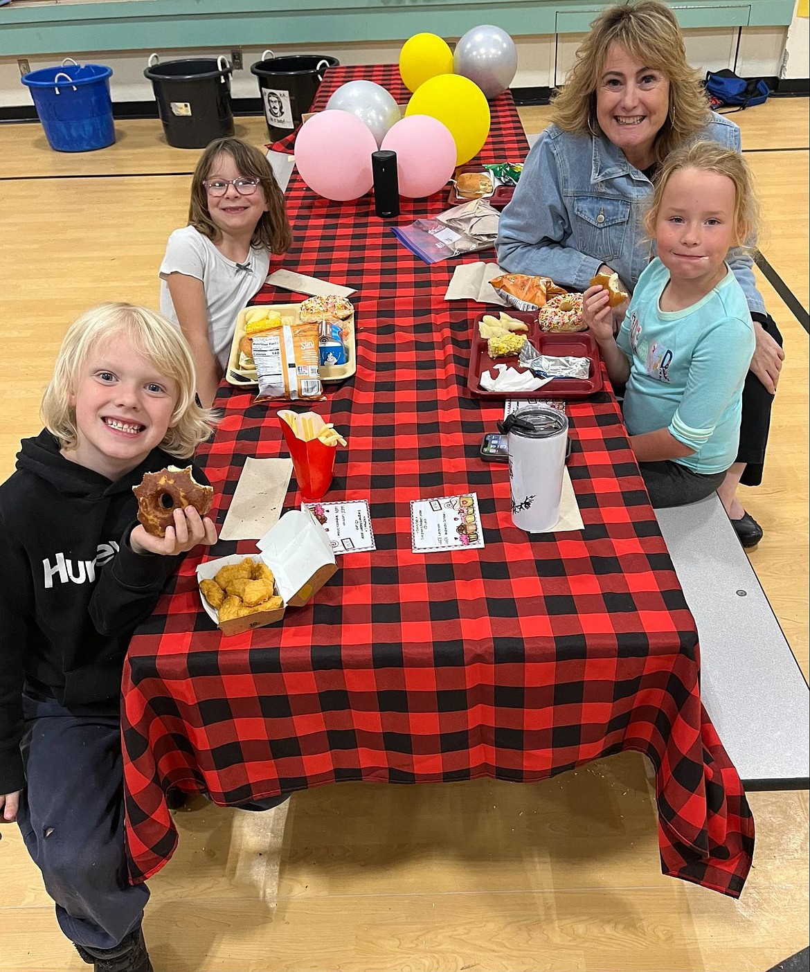 Aleah Jorden, Matthew Christensen, Harper Davis and Counselor Michelle Mitchell at the second grade VIP lunch at East Evergreen Elementary School.