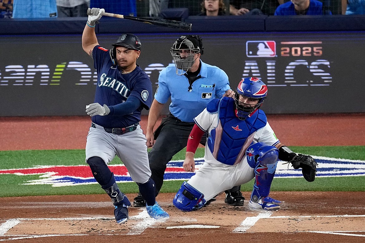 Seattle Mariners' Josh Naylor follows through on an RBI base hit off Toronto Blue Jays pitcher Shane Bieber (57) during the first inning in Game 7 of baseball's American League Championship Series, Monday, Oct. 20, 2025, in Toronto.