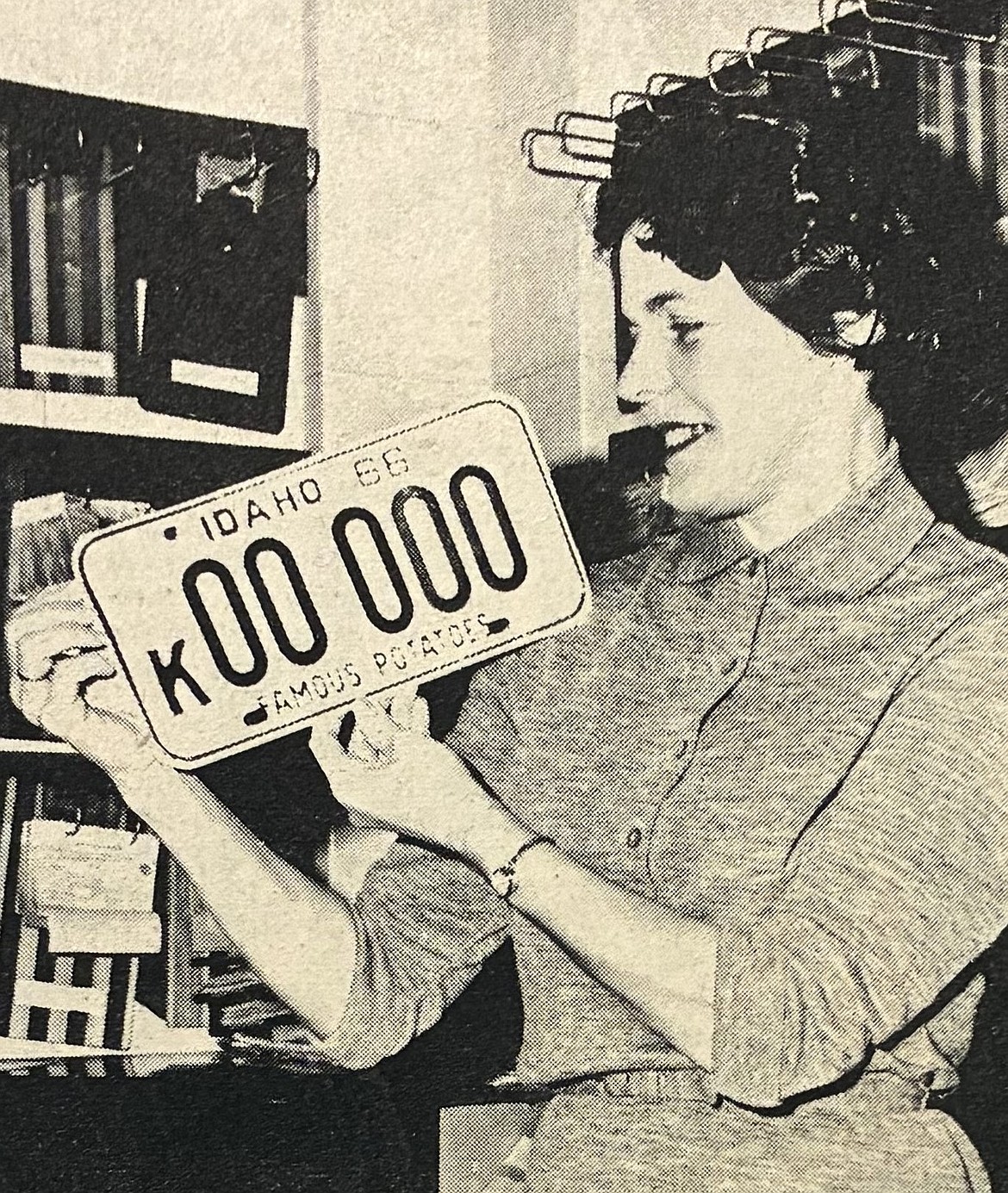 In late 1965, Imogene Shively of the Kootenai County Licensing Department reveals the new 1966 Idaho vehicle plate.