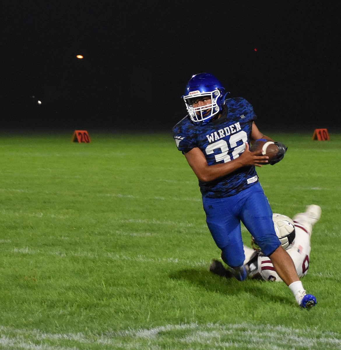 Senior running back Tavo Canales from the Cougars rushes past a defender in a game at the start of the season.