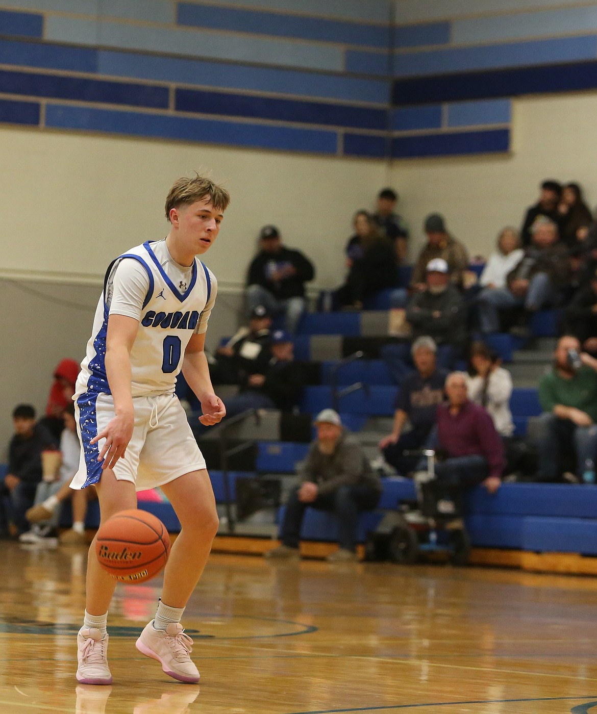 Cougars player JJ Madsen, who was a freshman on the squad last season, approaches the three-point line during a matchup last season.