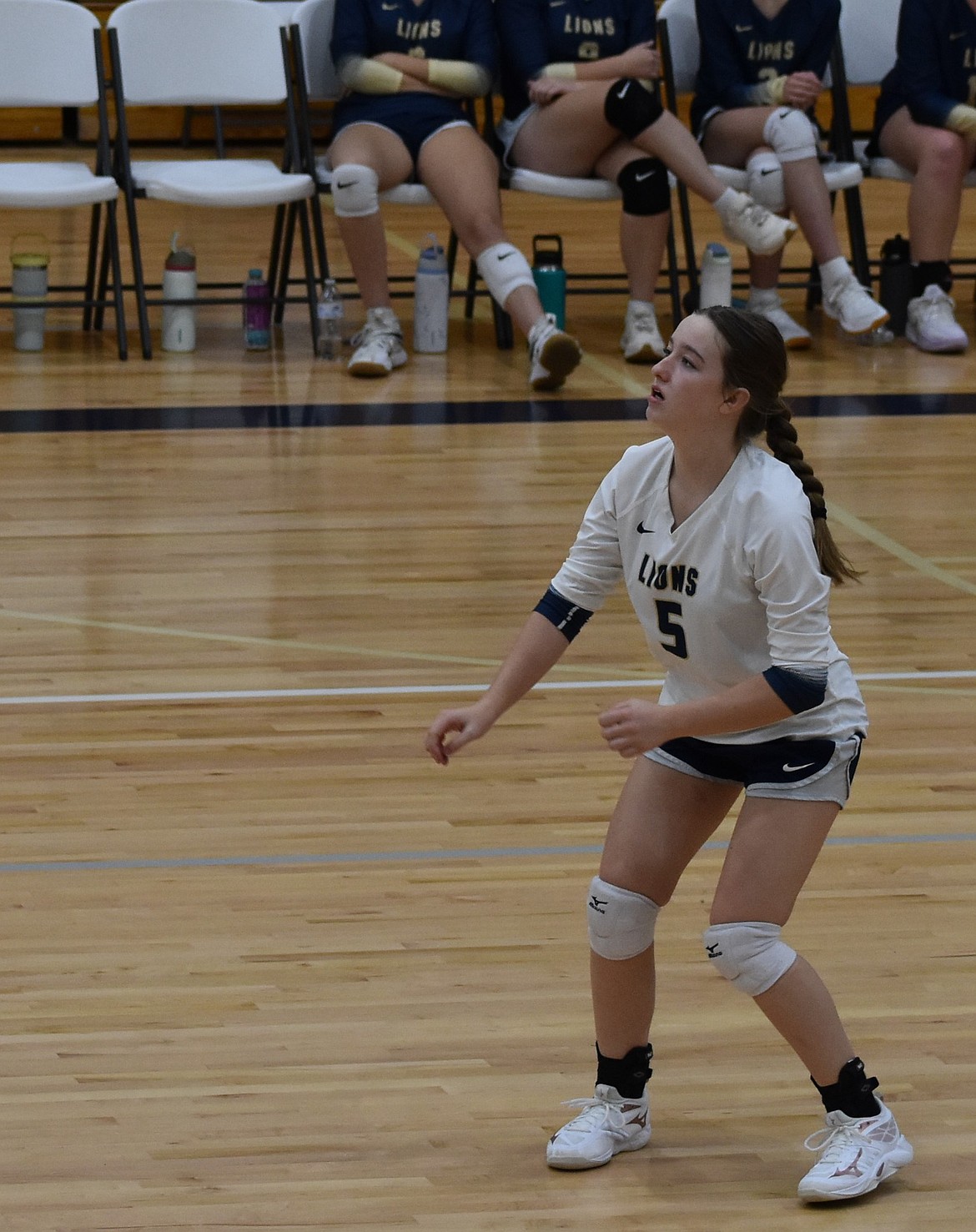 Vesta Koethke from the Lions keeps an eye on the ball on the other side of the net and stays prepared for the chance to hit the ball back over.