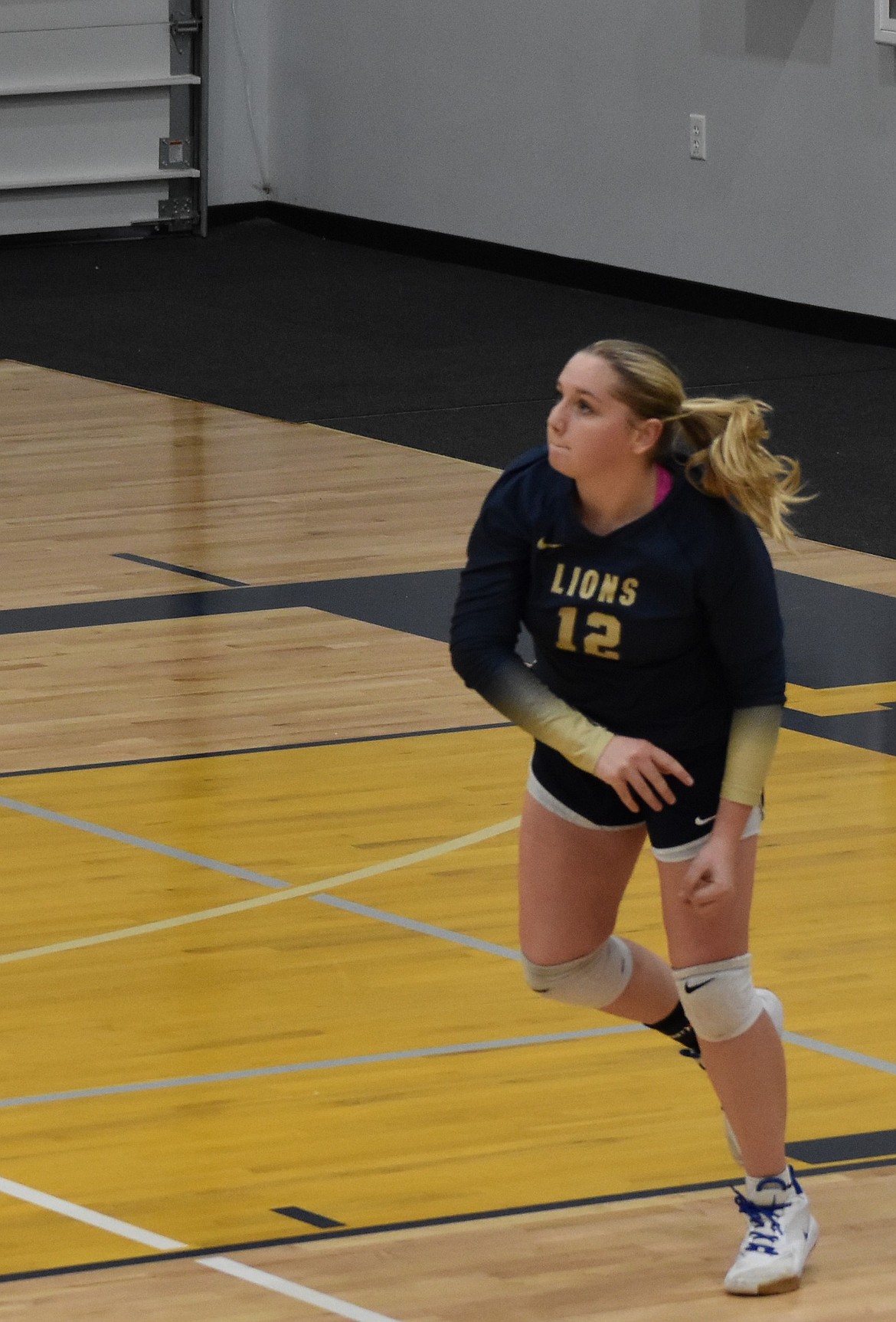 MLCA/CCS’s Ava Bishop runs toward the court after serving the ball during a home game this season.