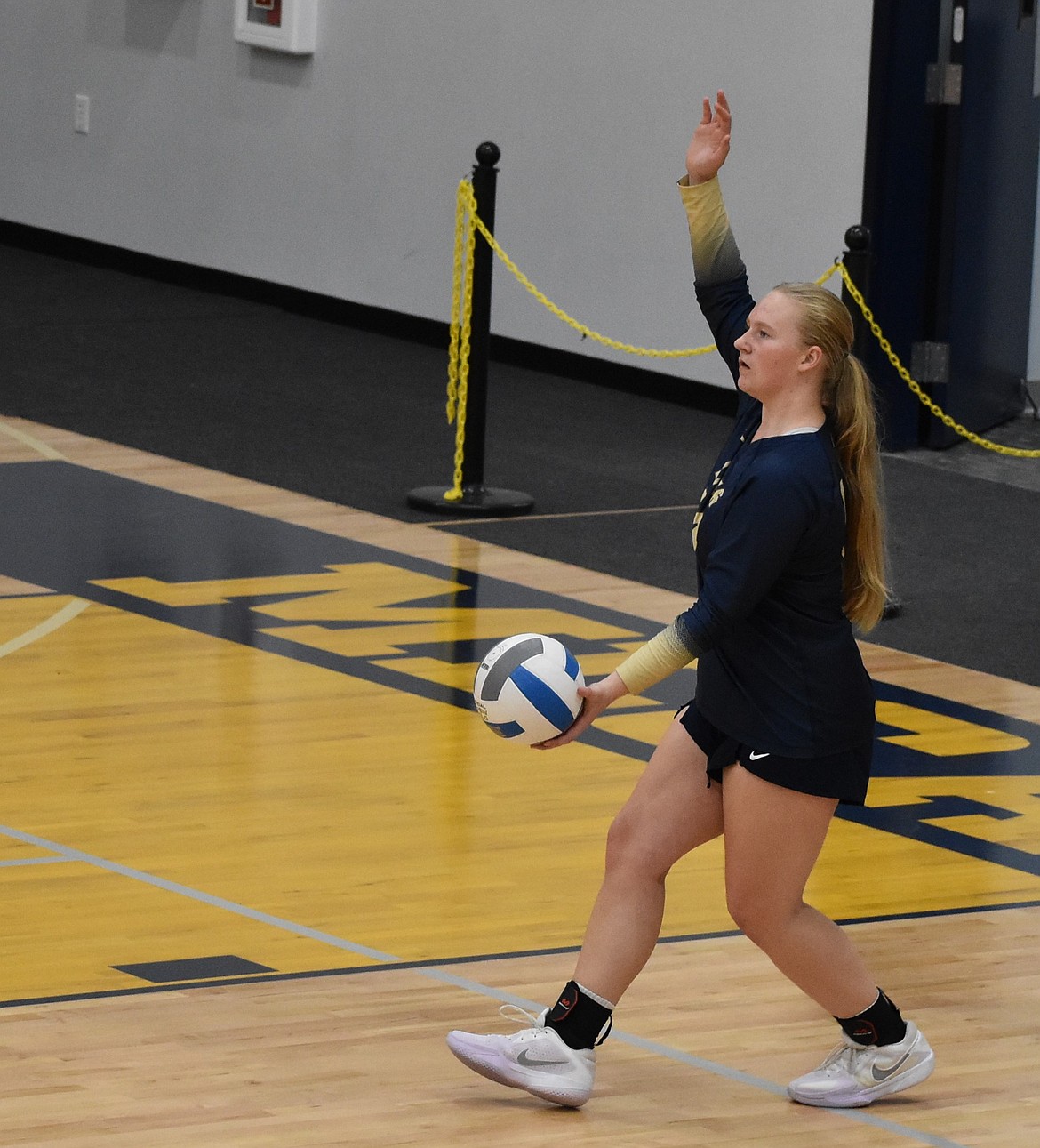 Abby Stanley, a junior for the Lions, gets ready to serve the ball to her opponent during a home game at the start of the season.