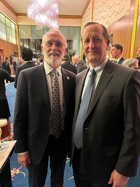 Washington Fourth District Congressman Dan Newhouse, left, meets with USApple president Jim Bair, right, at a reception in Washington, D.C.