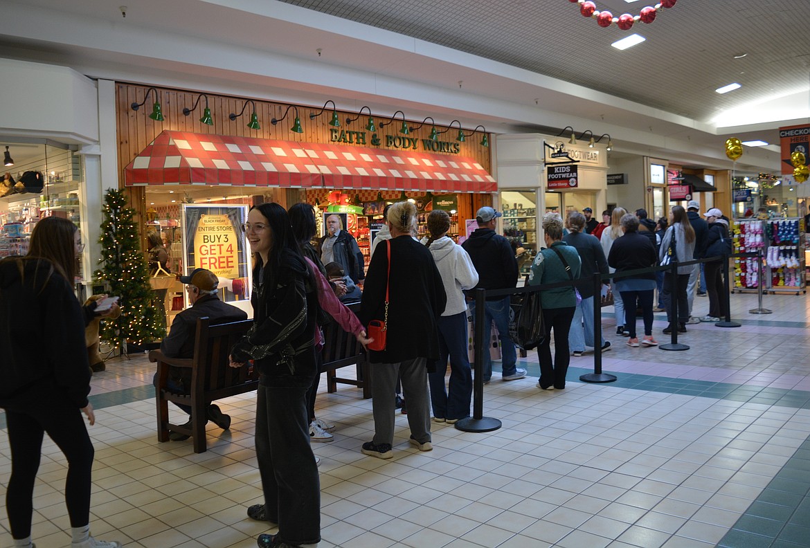 Shoppers wait their turn to do their Black Friday shopping at Bath and Body Works at Silver Lake Mall.