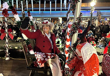 Tammy Wasson waves to the crowd during Friday's Christmas parade in downtown Coeur d'Alene.