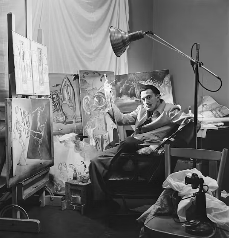 Surrealist artist Salvador Dalí poses with his oil paintings at his New York City studio in 1943.