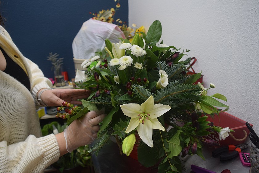 The Floral Cottage Owner Liz Graaff works on a centerpiece during her open house Monday. Graaff makes unique flower arrangements based on a customer's wants and desires.
