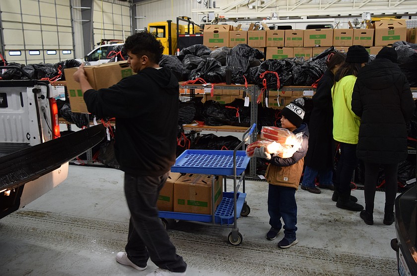 Volunteers load Christmas baskets for distribution at the Adams County Fire District 5 fire station in 2024. Donations for the 2025 Christmas basket program are being accepted now.