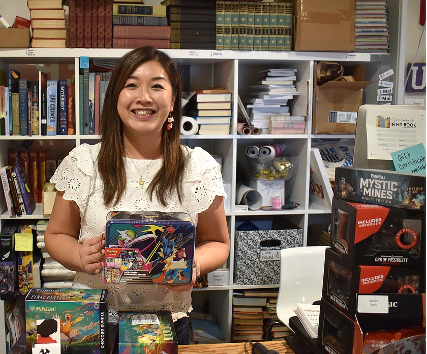 Mai Houvener, owner of The Sandbox Bookstore in Moses Lake, holds up a Pokémon gift kit. Pokémon items are selling as fast as they hit the shelves, she said.