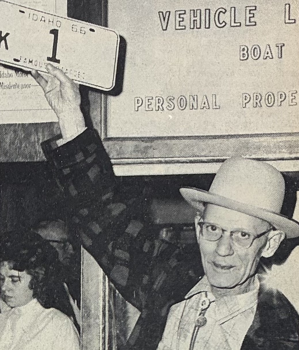 Harold Hooper, of Coeur d’Alene, holds his new vehicle license plate after waiting all night at the courthouse in 1965.
