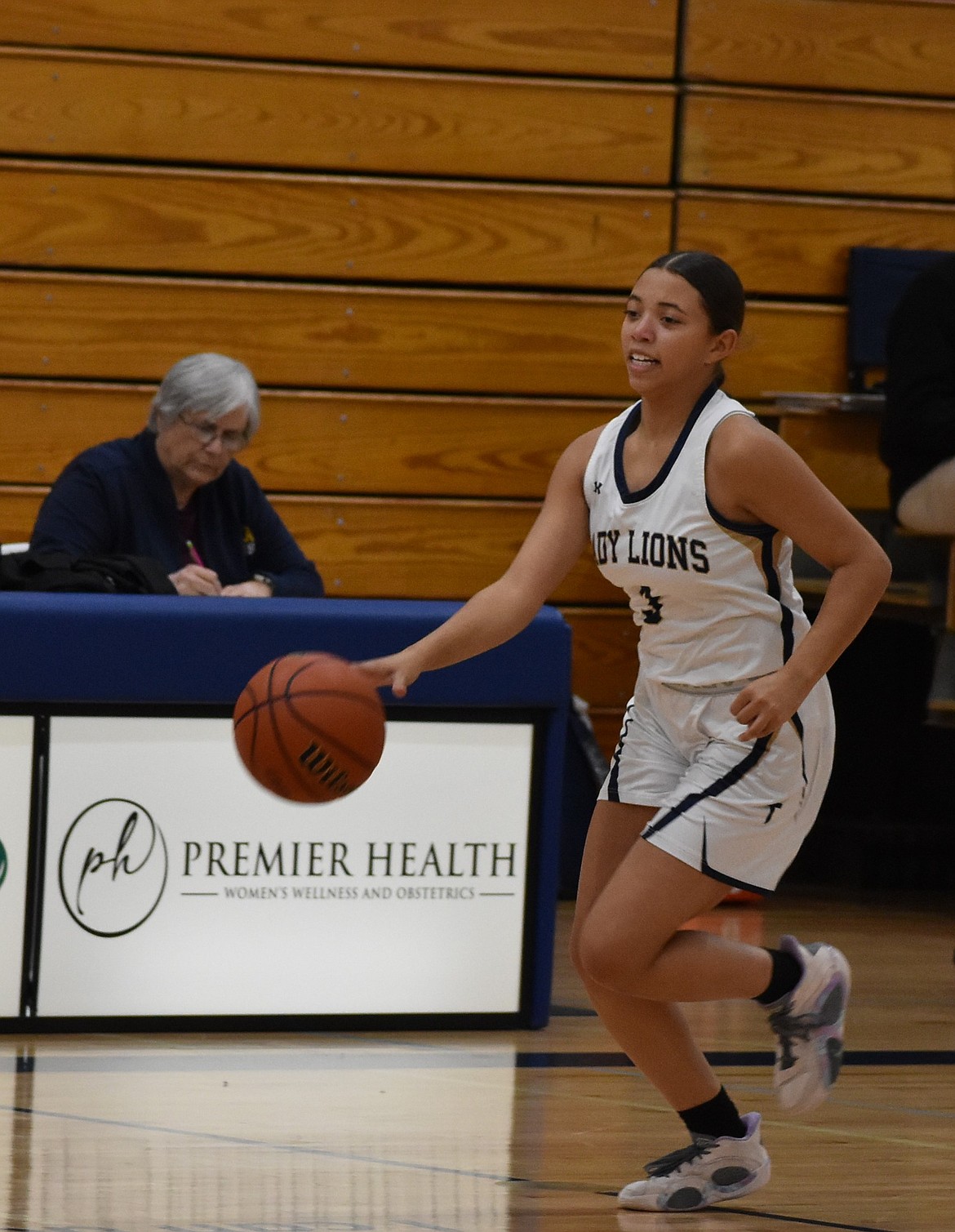 Lions freshman Zoey Ferguson sprints down the court toward the hoop during Wednesday’s game against Entiat.